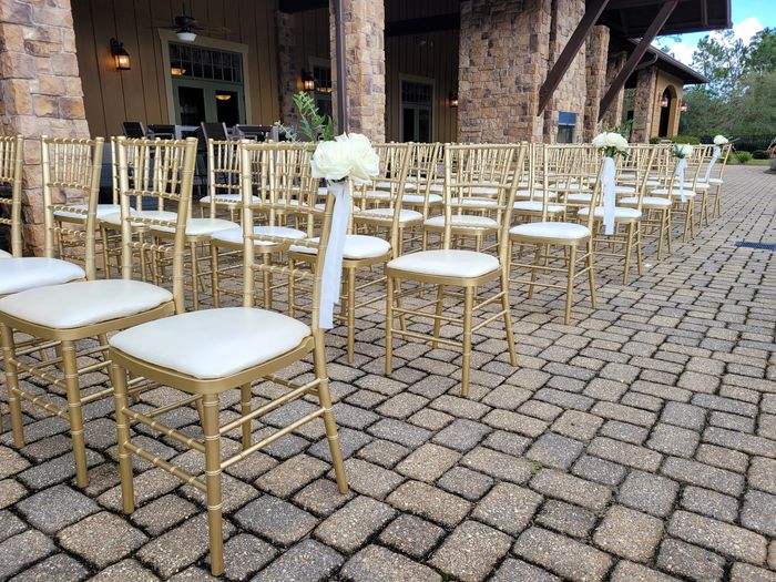Gold Chiavari Chairs setup on patio for wedding ceremony.