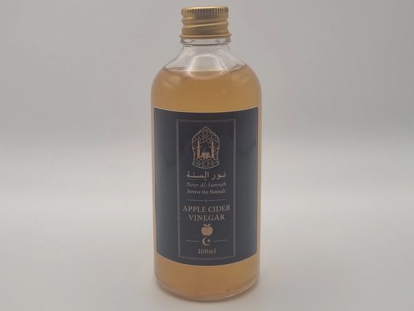 Bottle of apple cider vinegar with black label.