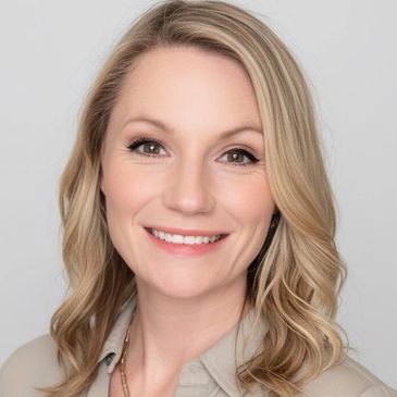 Smiling woman with blonde hair posing against a plain background.