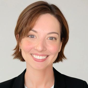 Smiling woman with short brown hair and a black blazer.