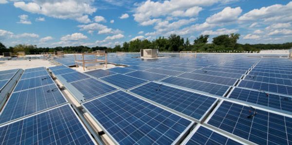 Large-scale commercial solar panel array on a flat rooftop.