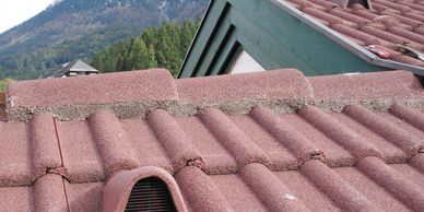 Close-up of a red concrete tile roof with mortar cement