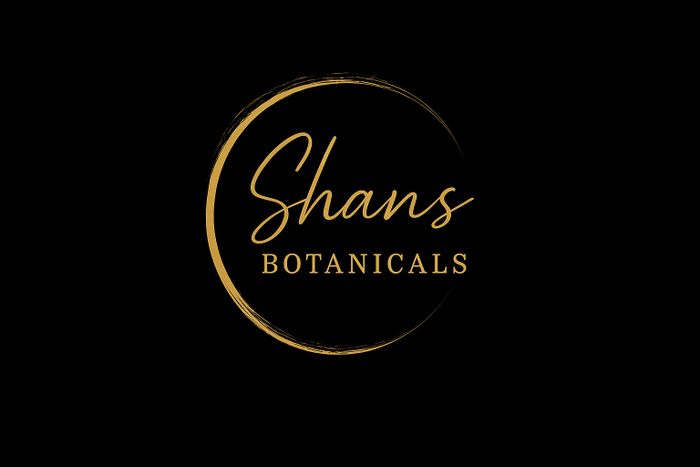 Elegant gold logo for Shans Botanicals on black background.