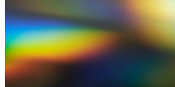 Close-up of a microphone in a radio studio with an 'ON AIR' sign.