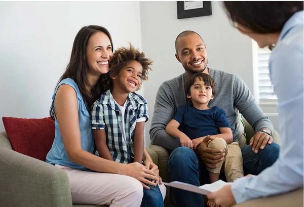 Family therapy with black male therapist to discuss mental health issues.