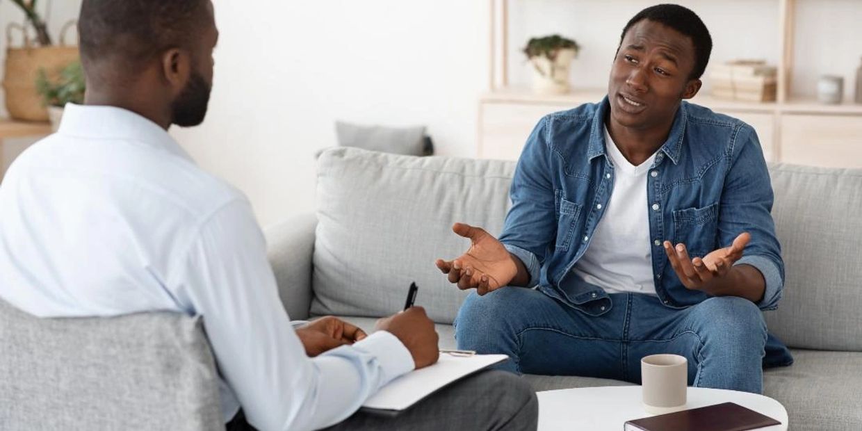 Two men engaged in a counseling session.