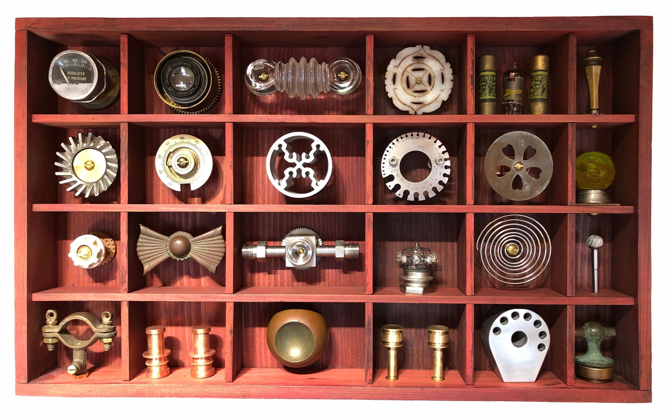 A collection of 24 random items in a wood box.