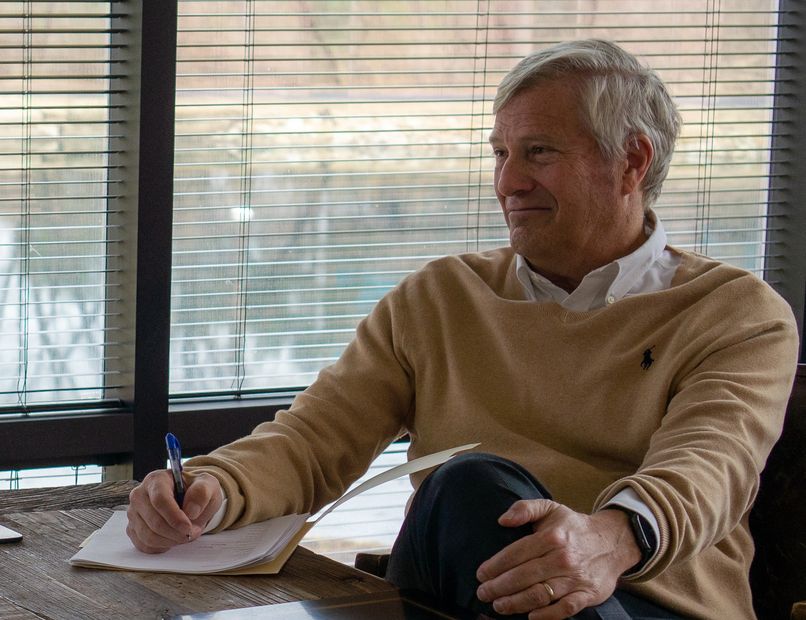 Greg Kincaid, a Kansas City Divorce Attorney, sits at his desk and answers client questions.