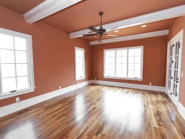 This beautifully painted room showcases warm, earthy wall tones paired with bright white trim.