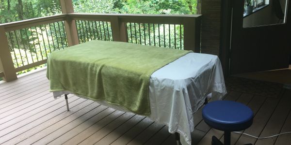 Receiving your treatment outside on the deck surrounded by forest...
