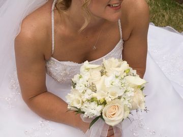 Bride holding a bouquet of various white flowers