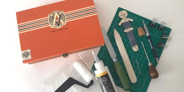 Bookbinding tools with a wooden cigar box