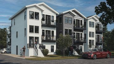 Modern apartment complex with balconies and people outside.