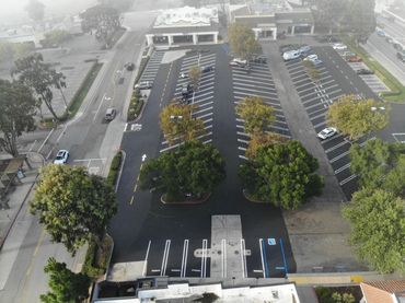Aerial view of a commercial parking lot paved and striped by Integrous Paving.