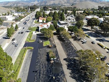 Aerial view of a commercial parking lot paved and striped by Integrous Paving.
