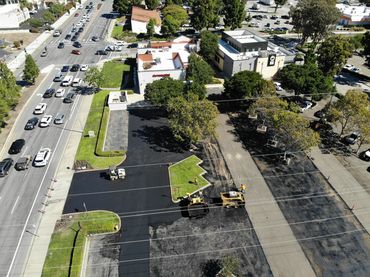 Aerial view of a commercial parking lot paved and striped by Integrous Paving.