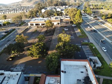 Aerial view of a commercial parking lot paved and striped by Integrous Paving.