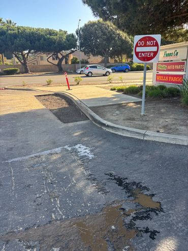 This image is before repairs, showing cracked pavement and potholes.