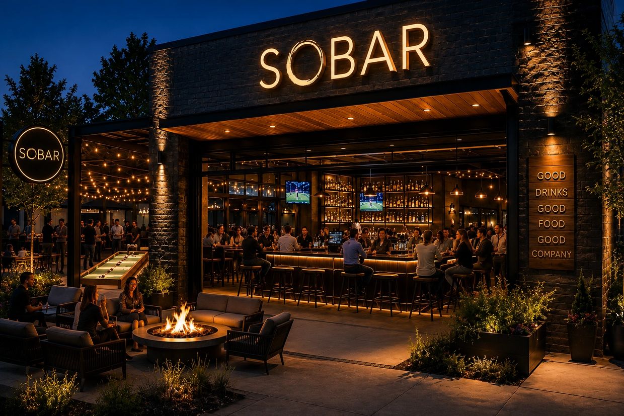 Nighttime view of a lively bar named SOBAR with people enjoying drinks indoors and outdoors.
