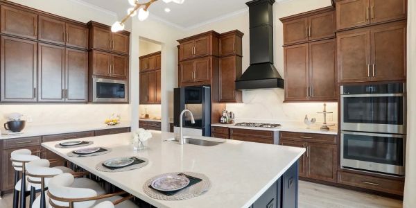 Modern kitchen with dark wood cabinets and a large island.
