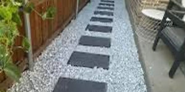 Pathway with stepping stones on gravel.