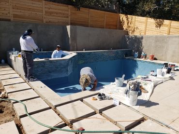 Islander Pool & Spa crew installing tile and plaster during a pool remodel