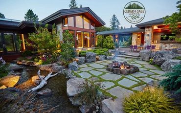 Beautiful backyard with stone patio, fire pit, and natural landscaping.