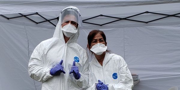 During our community drives, Jesse, MICT (left) and Dee, RN (right) were all smiles behind their mas