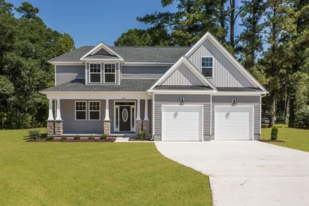 Newly built home exterior painted soft gray and trim high gloss white