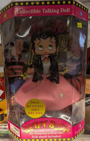 Betty Boop collectible talking doll in retro packaging with a pink skirt and black jacket.