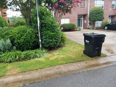 Curbside junk pickup in progress outside a multi-family property