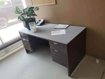 Used office desk and drawers being hauled away from downtown suite