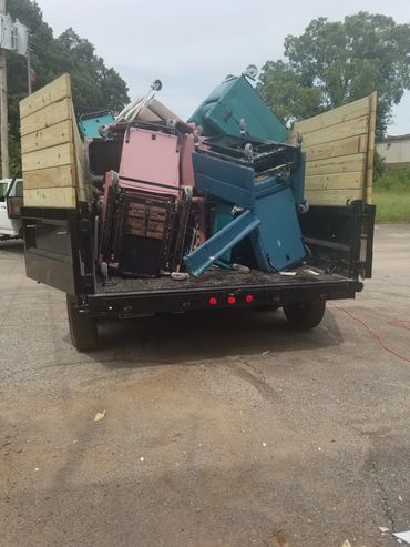Haul Squad trailer loaded with dismantled office chairs and scrap materials