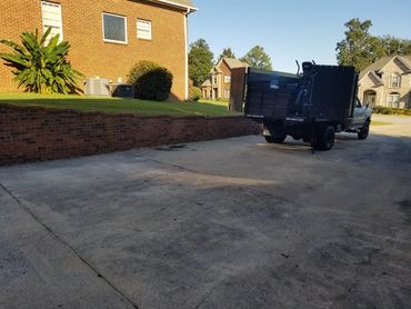 Driveway junk pickup in progress outside a Hoover house