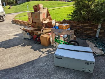 Curbside junk pile with furniture and debris in Birmingham neighborhood
