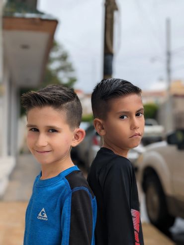two boys walking together through Degollado during Hill family visit