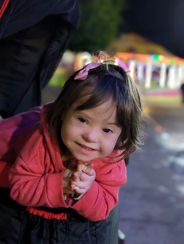 Young girl in red jacket smiling during Mexico vacation