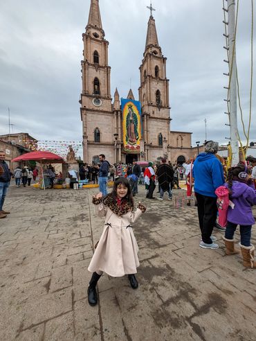 Family walking toward church plaza in Degollado, Jalisco