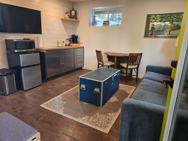 Bright kitchen/living room includes a hide-a-bed for extra guests.