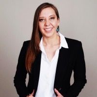 Professional woman in business attire smiling confidently.