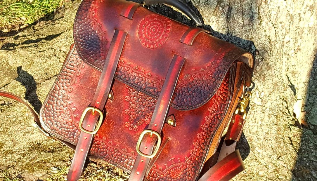 Distressed, hand tooled, hand dyed cowhide leather briefcase.