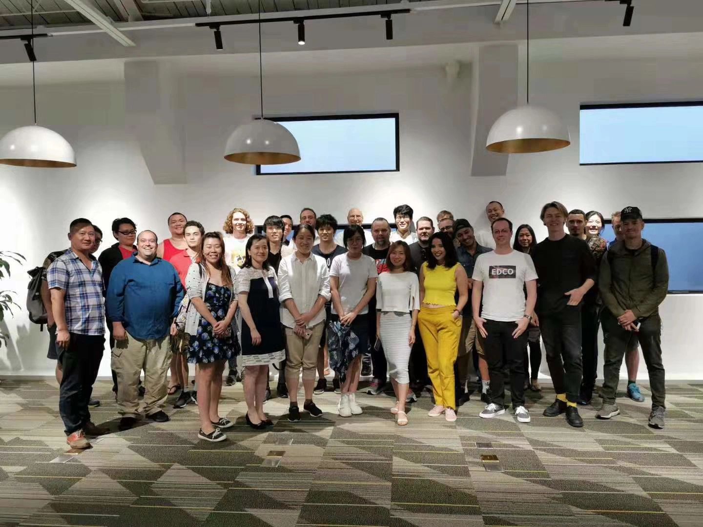 A diverse group of people posing indoors under modern lighting.