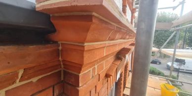 Close-up of decorative brickwork on a building facade under construction or renovation.