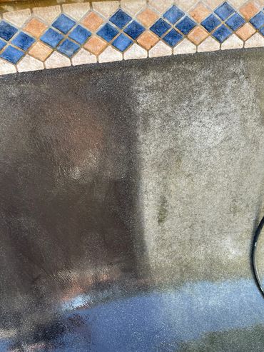 Pressure washing reveals a stark contrast between clean and dirty concrete surfaces.