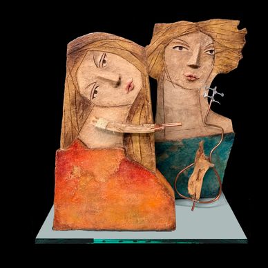 Abstract sculpture of two women with elongated features.