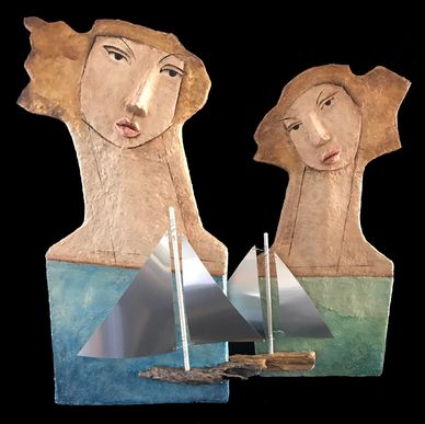 Sculpture of two heads with sailboats.