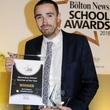 GCSE Teacher holding an award