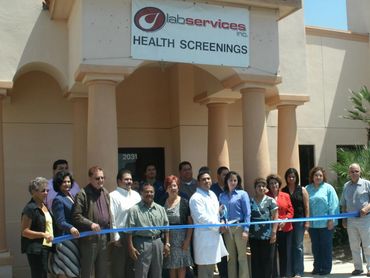Group gathered for ribbon-cutting at Lab Services Health Screenings.