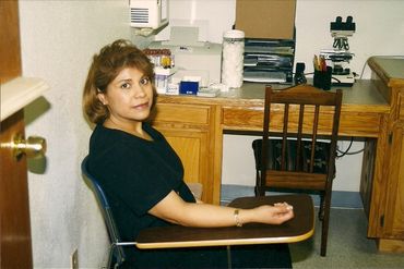 Woman sitting in a clinic room, ready for a medical test.
