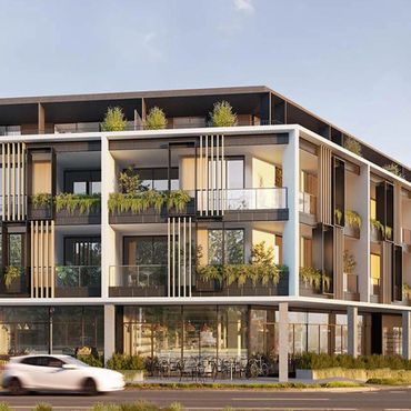 Modern apartment building with balconies and greenery.